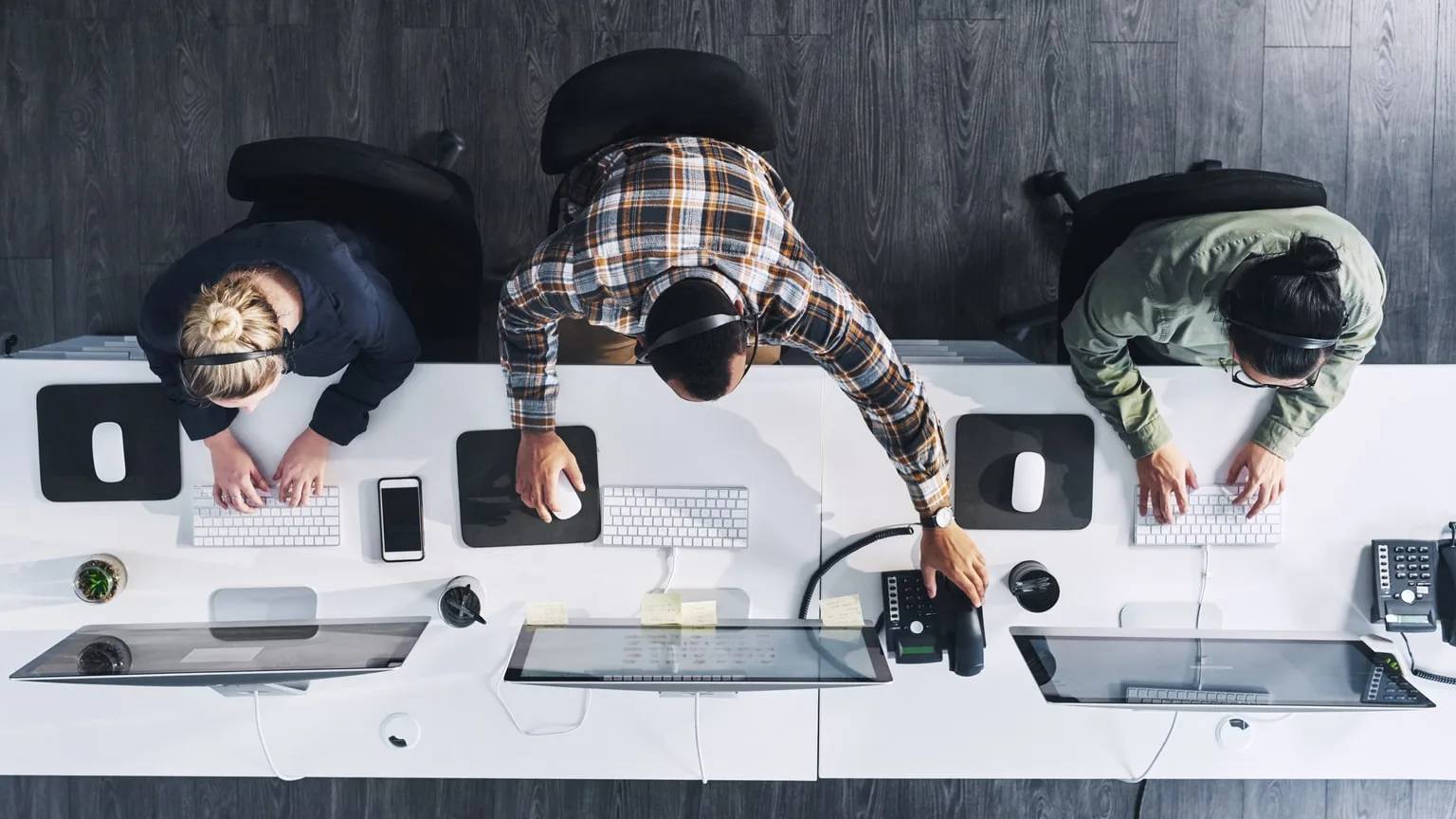 Image: Getty Images Row of people using the internet on desktop computers
