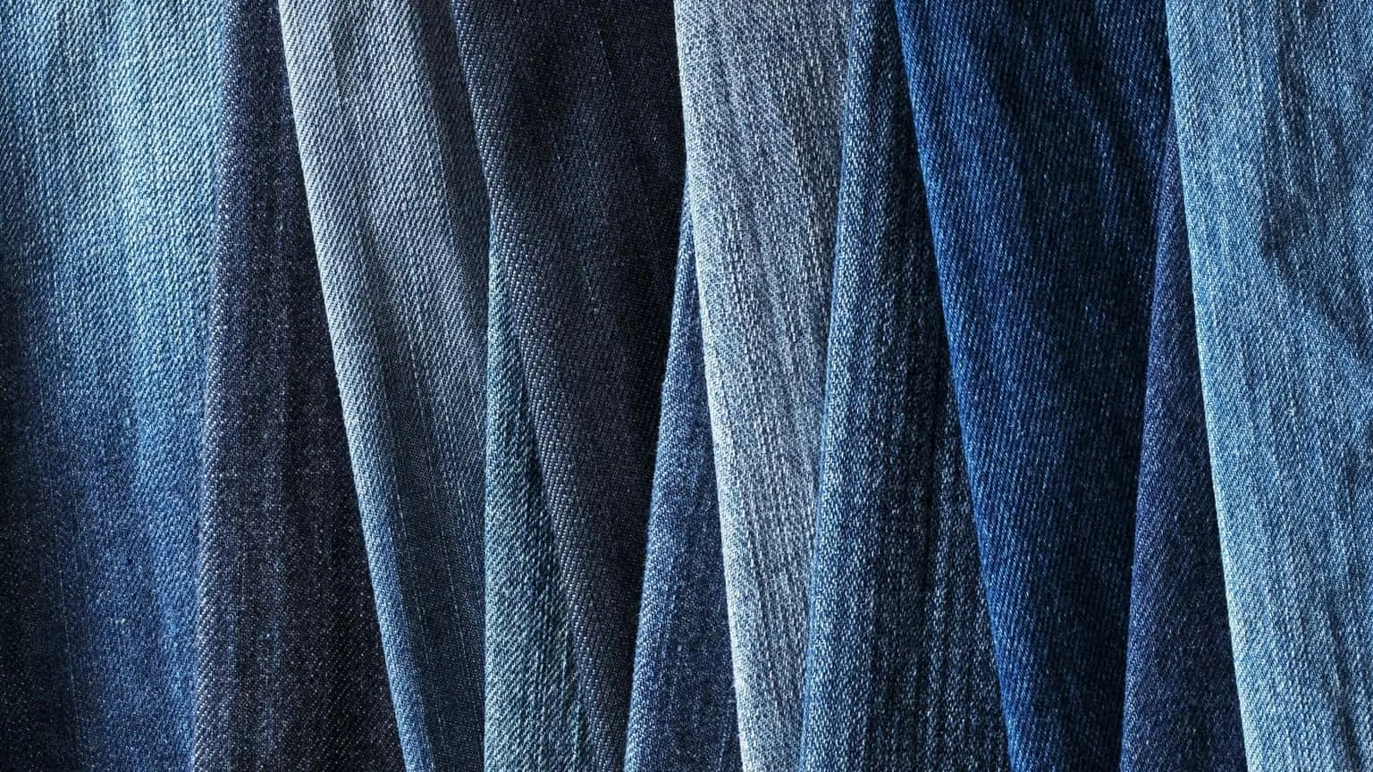 Image: Getty Images Closeup of jeans hanging in a closet
