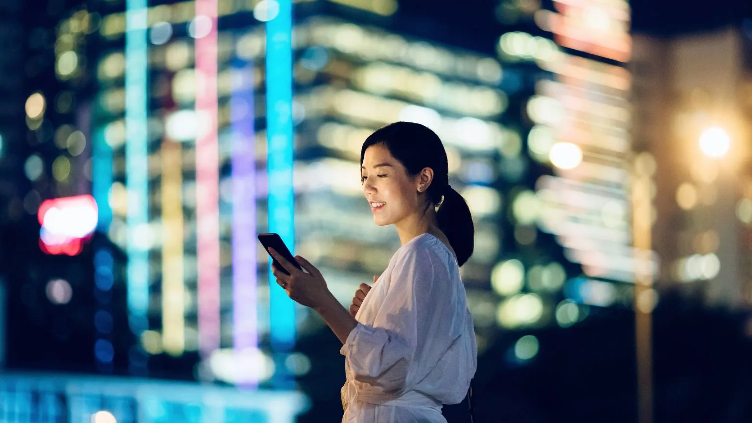 Image: Getty Images Smiling Woman With Phone