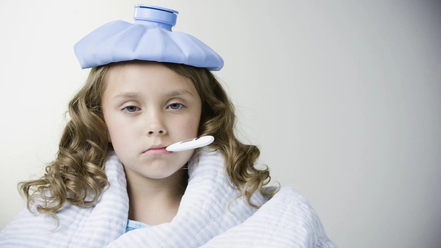 Image: Getty Images Little girl with a thermometer