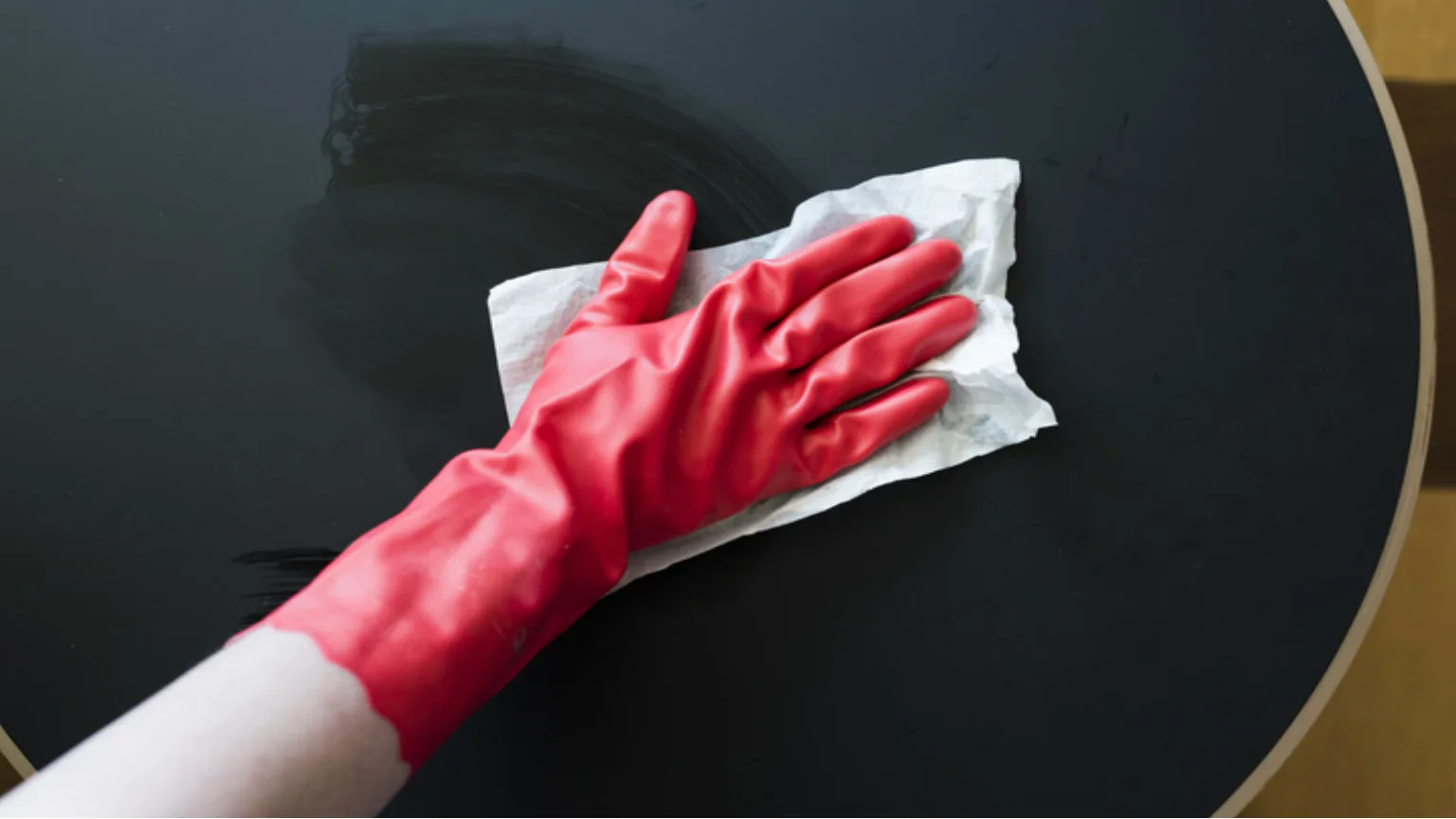 Image: Getty Images Model wiping table with surface disinfectant wipes
