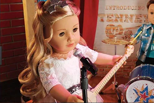 doll with a guitar and a mic in front of her